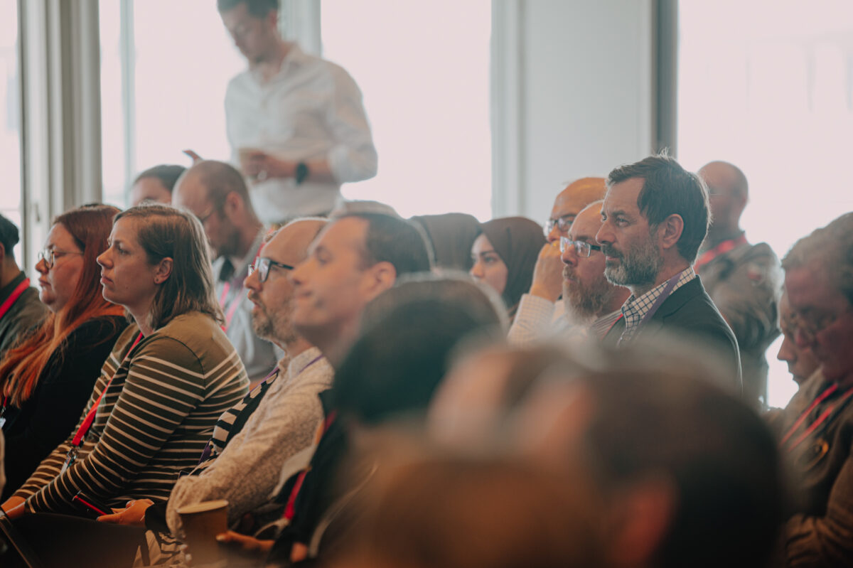 A partly blurry image of a small section of audience in a conference